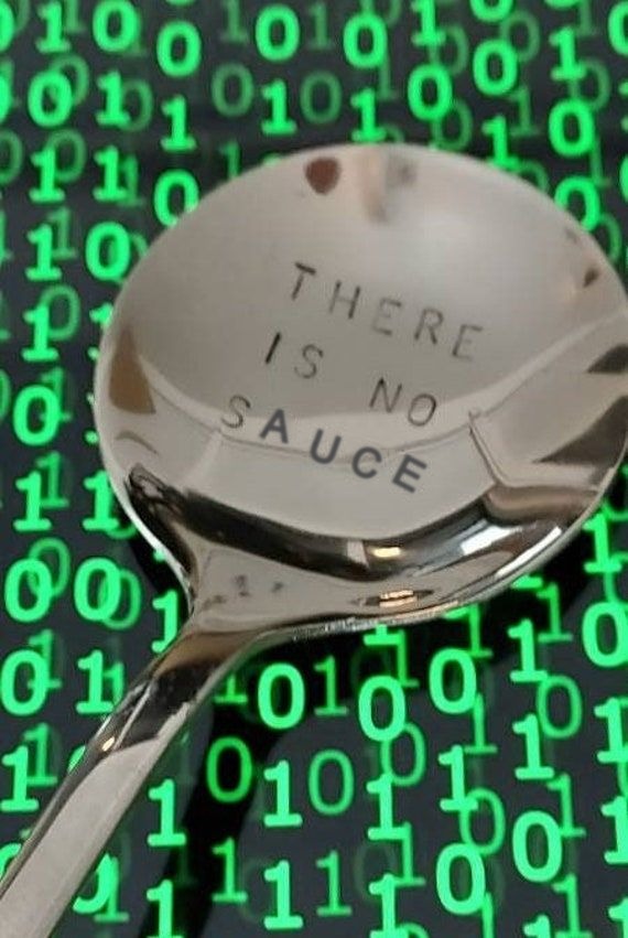 A spoon stamped ‘there is no sauce’ against green falling code.
